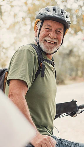 Senior man riding a bike outdoors