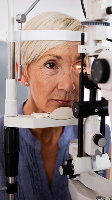 senior woman having eyes examined