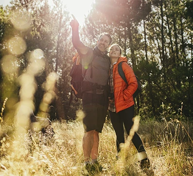 couple in their 40's enjoying hike in the woods